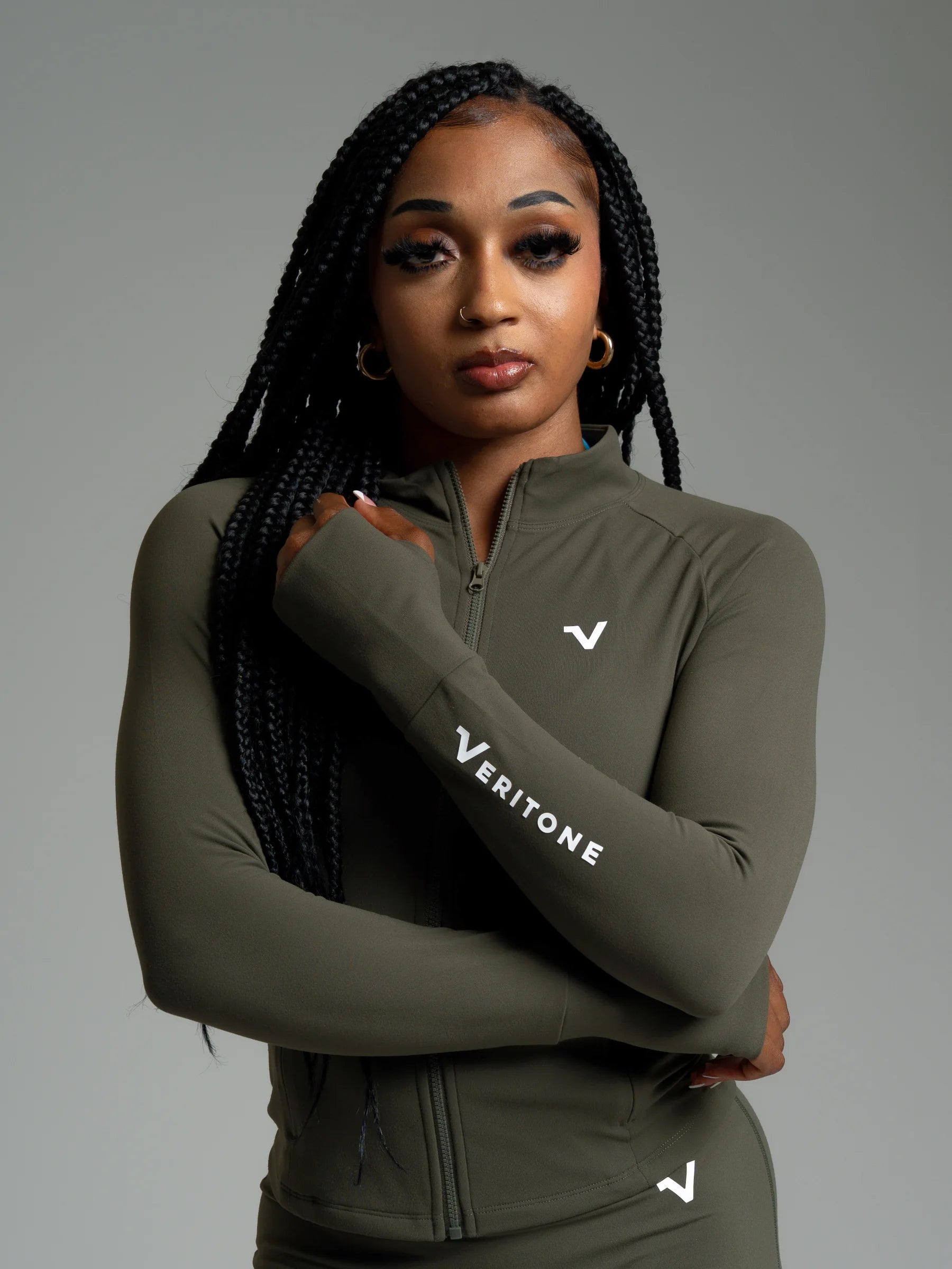 Woman wearing Veritone activewear representing the "Built on Belief" story.
