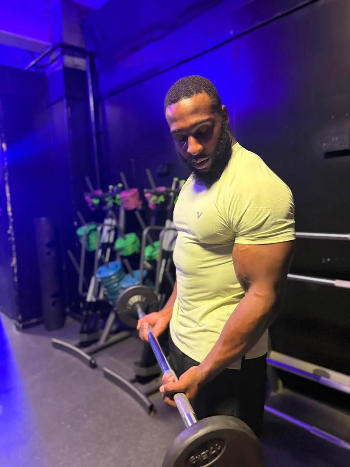 Man weight training in Veritone performance activewear.
