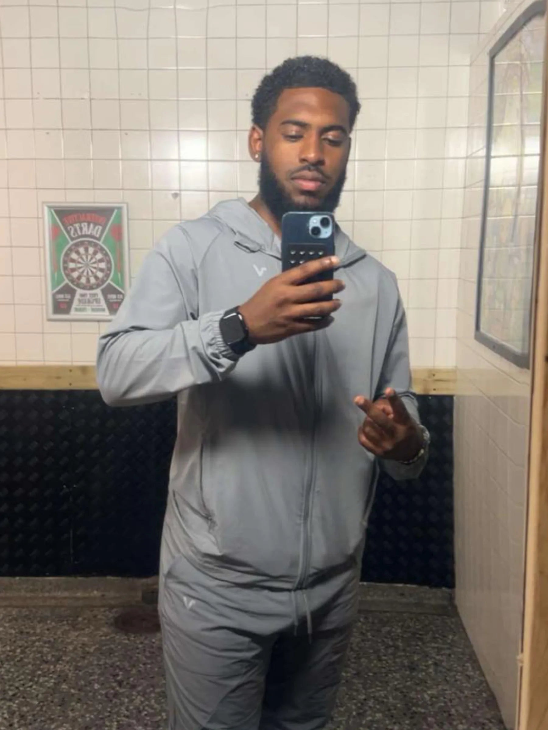 Man showcasing Veritone activewear in a mirror selfie.
