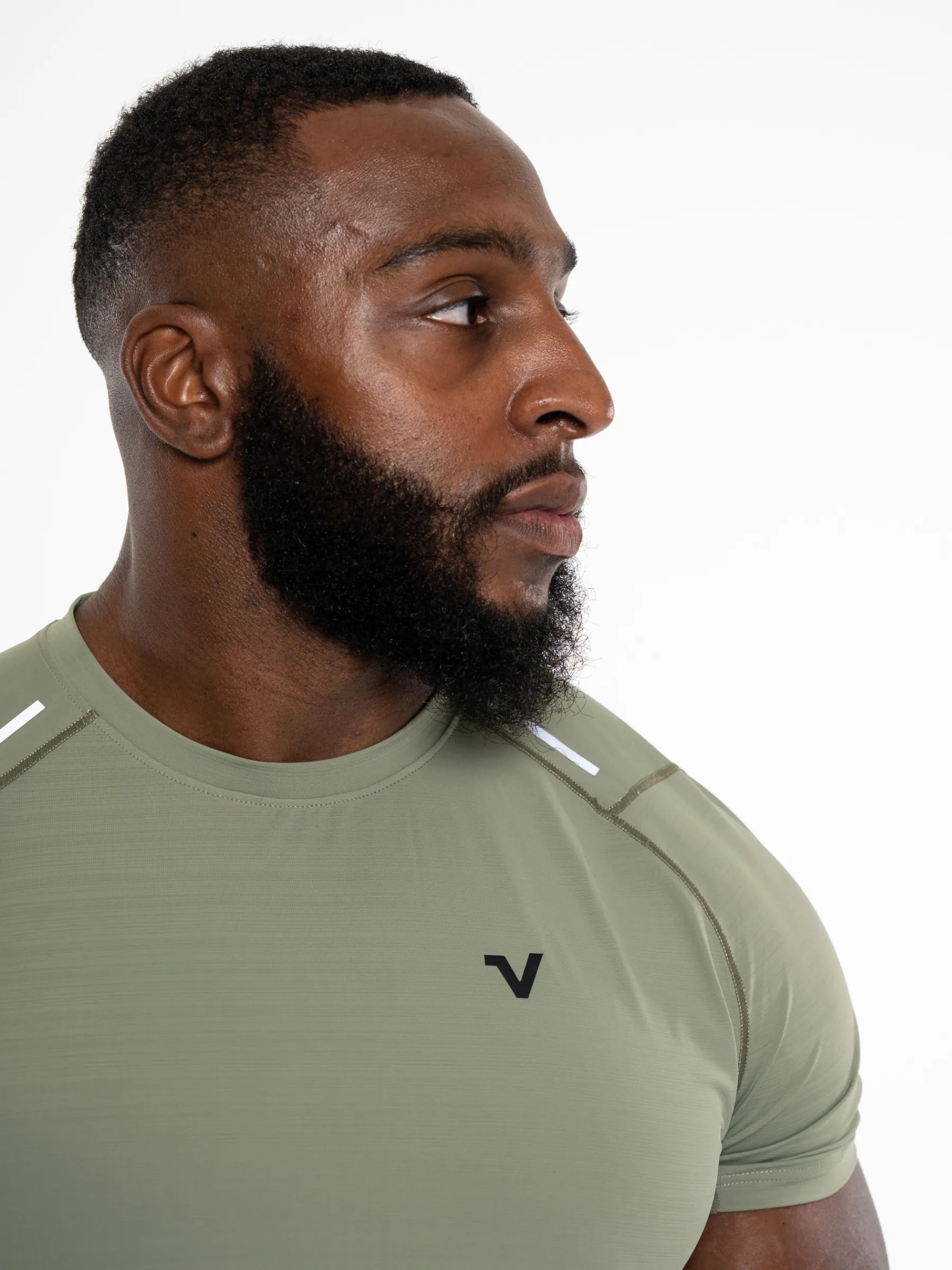 Veritone Prime Muscle Fit T-Shirt, Stone Khaki – Man wearing a green athletic shirt with a Veritone logo on a white background